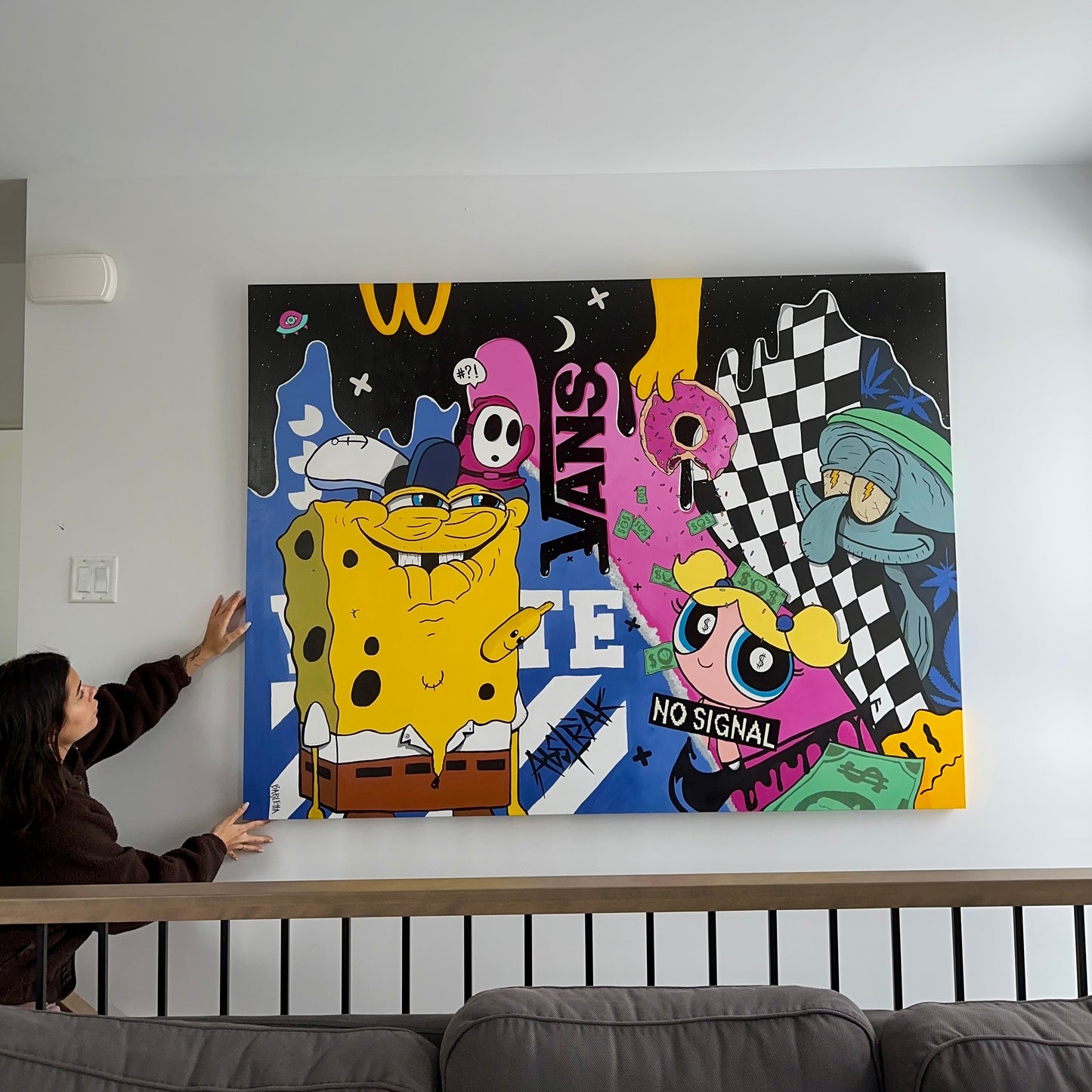 the artist Catherine Barletta with her playful acrylic artwork with hidden characters, donuts, and cosmic elements, creating a whimsical world of pop culture and humor.