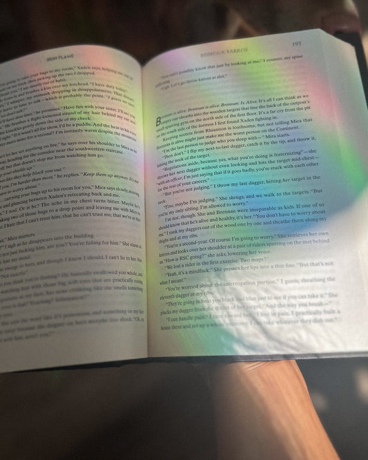 Open book with a rainbow reflection on it