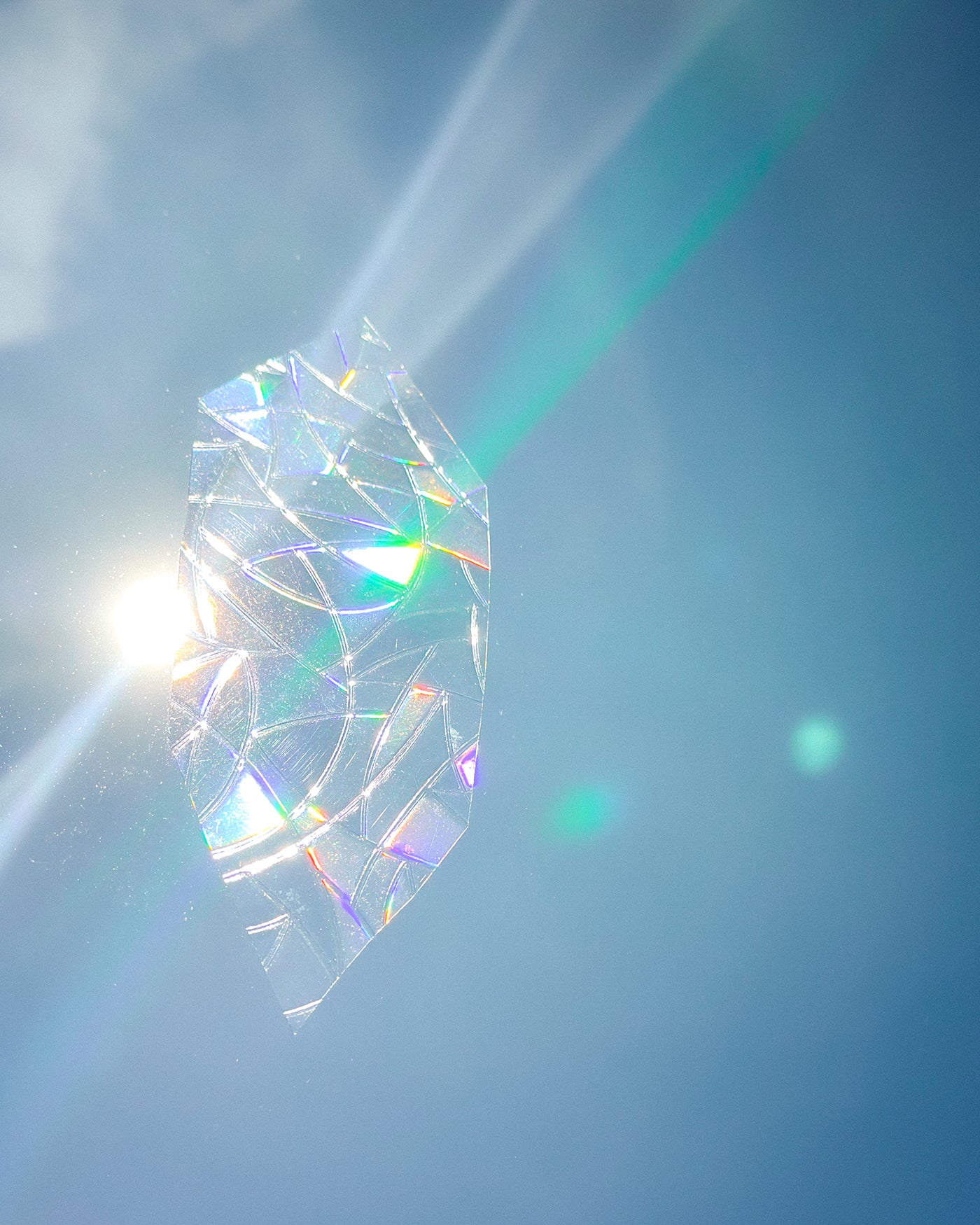 Crystal prism with rainbow colors on a blue background