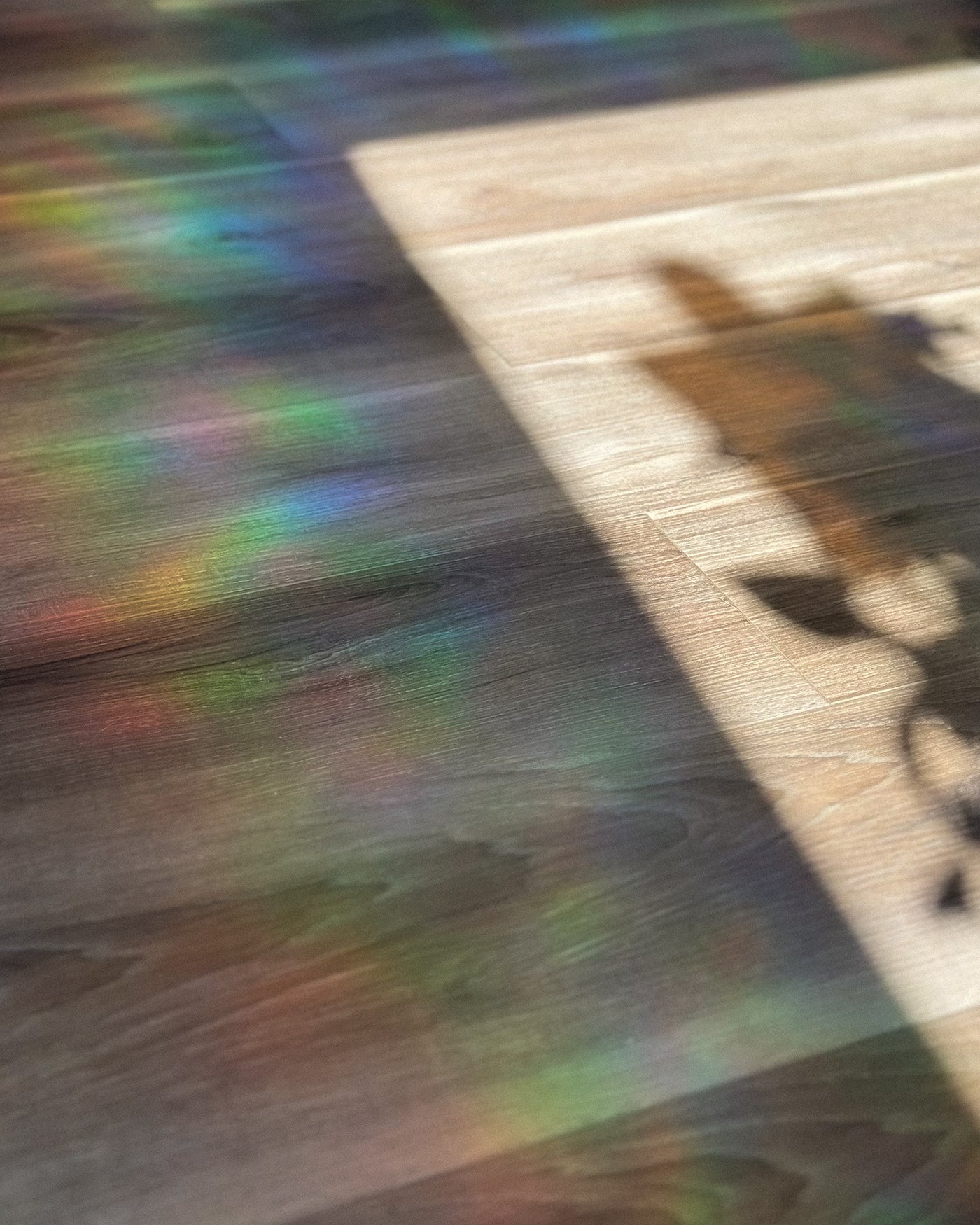 A wooden surface with colorful reflections