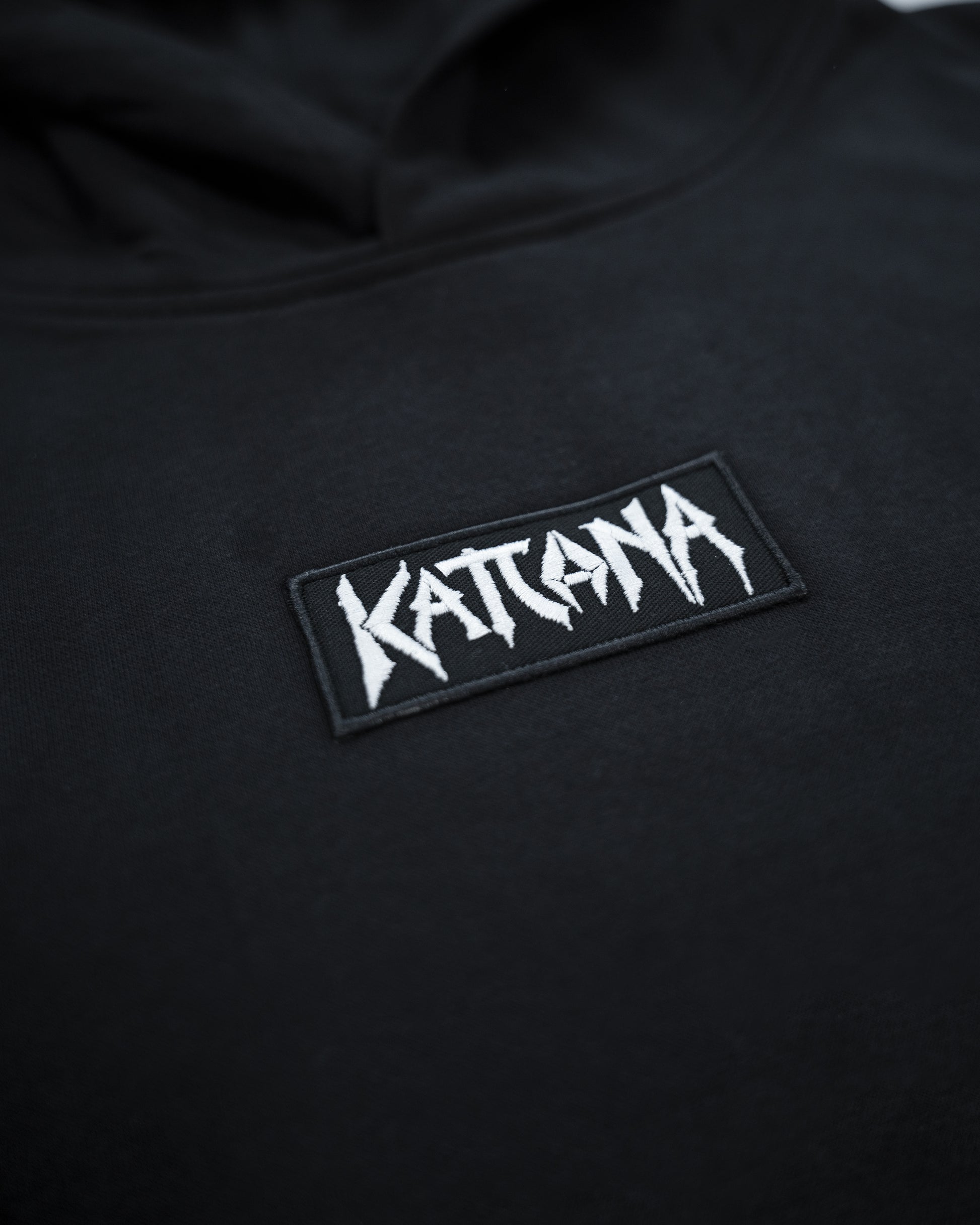 Black hoodie with 'Kattana' logo patch on a dark background