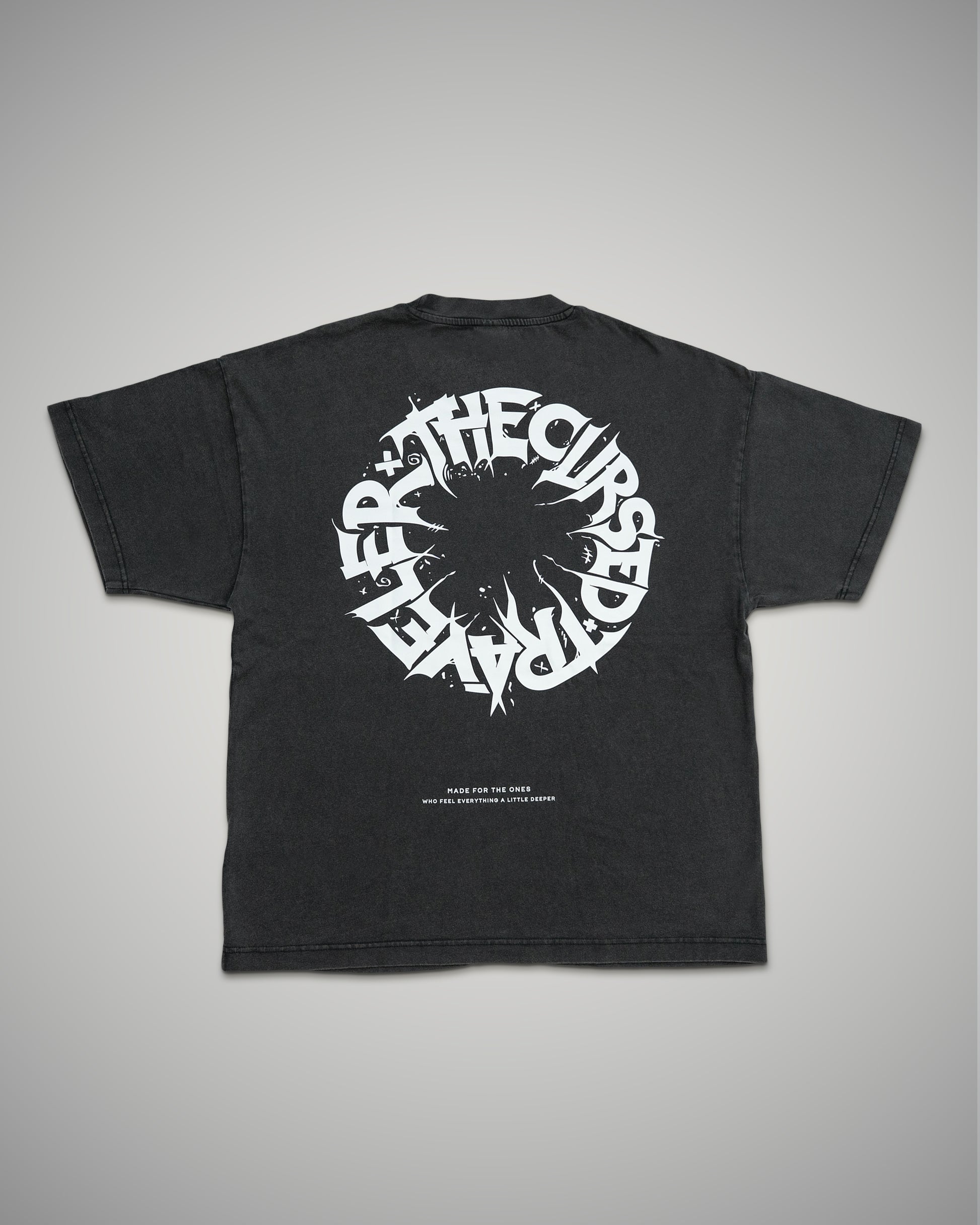 Black t-shirt with white graphic design on a gray background